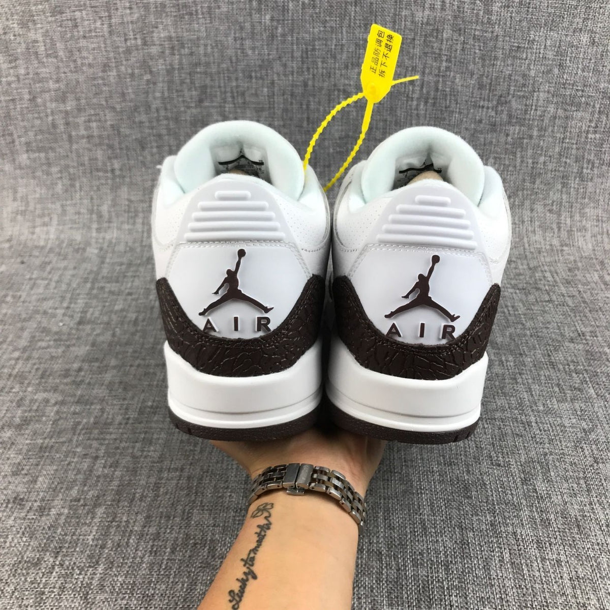 Rear view of the pair showing the Jordan branding and AIR lettering on the heel panels.