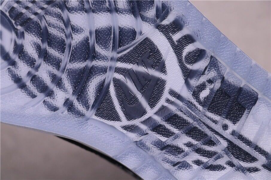 Close-up of the translucent outsole showing a dark printed winged basketball graphic.