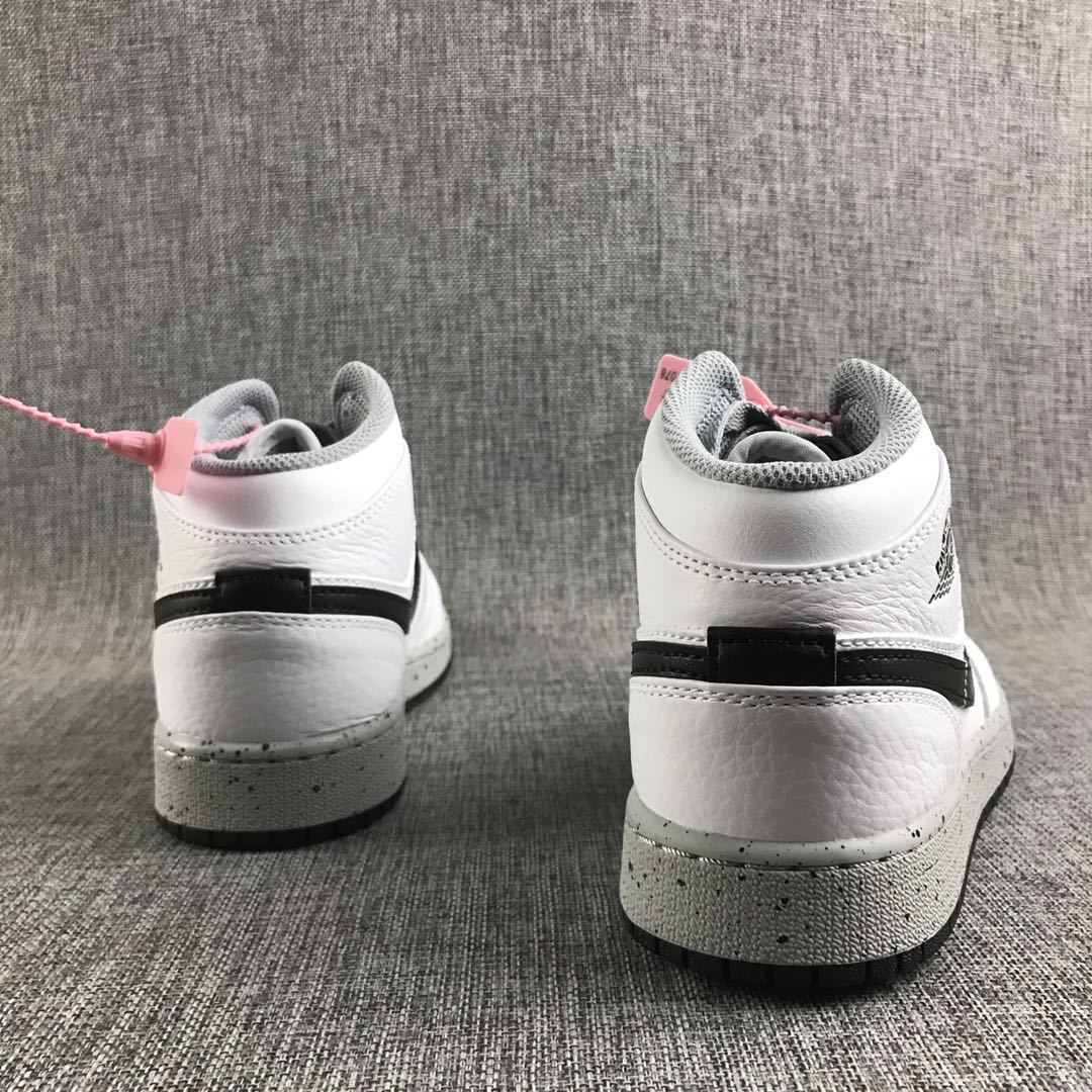 Rear view of the pair showing white heel panels, black horizontal accents, and speckled midsoles.