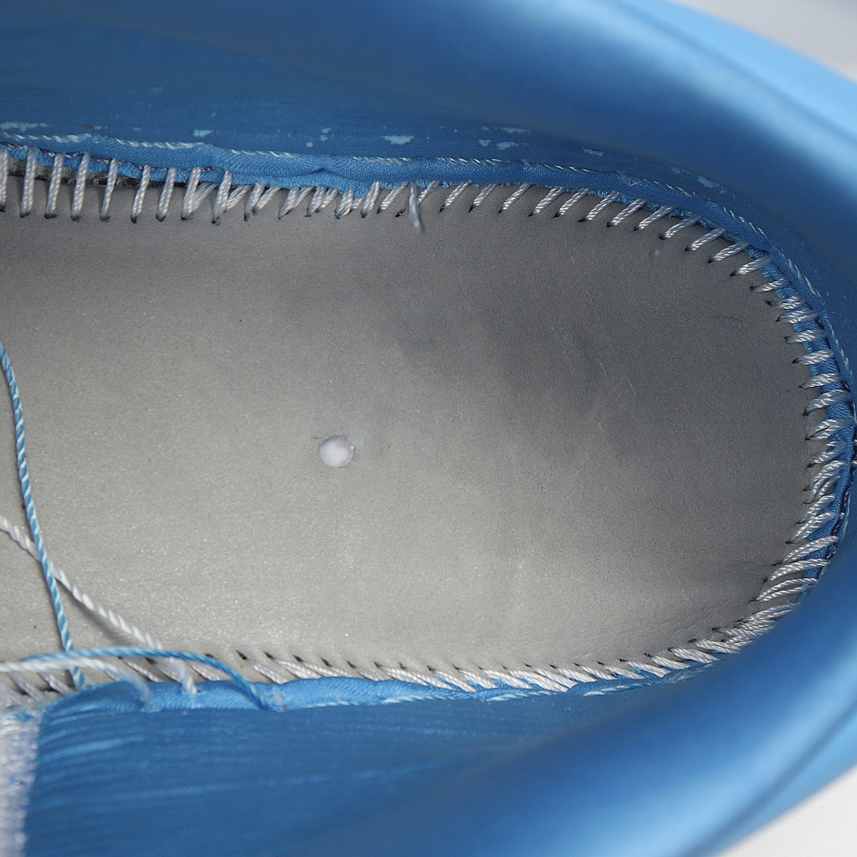 Close-up of the blue sneaker interior showing the lining and stitching.