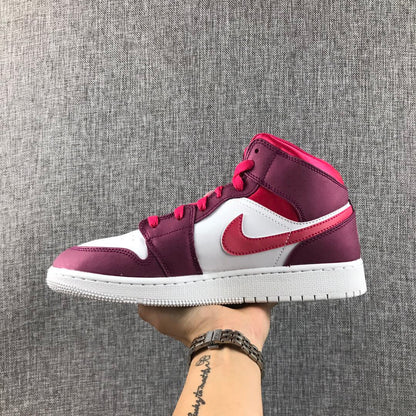 Side profile of the sneaker held in hand, showing the ankle collar and layered panels.