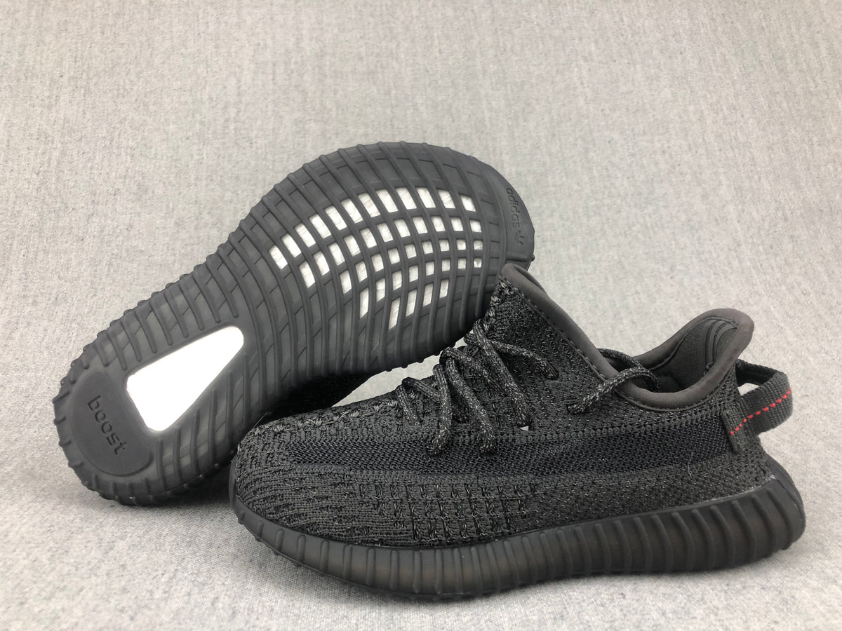 Black sneaker pair showing the outsole pattern, heel insert, and visible adidas branding.