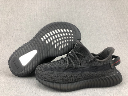 Black sneaker pair showing the outsole pattern, heel insert, and visible adidas branding.