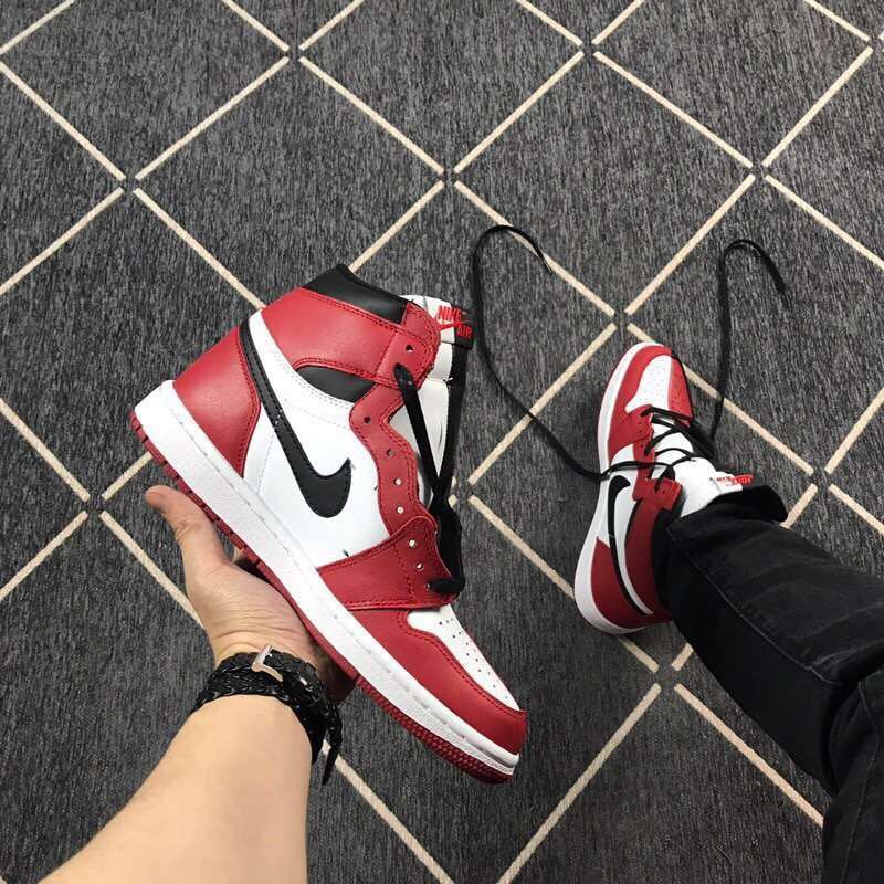 Angled view of a red, white, and black high-top sneaker showing the contrasting side Swoosh.