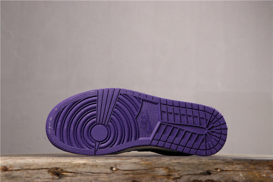Underside view showing the purple rubber outsole with circular pivot detail and patterned tread.