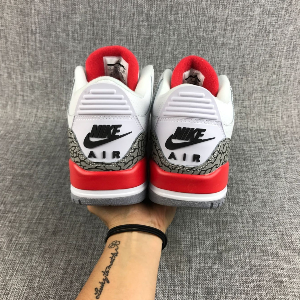 Rear view of the sneakers with heel branding and red accents