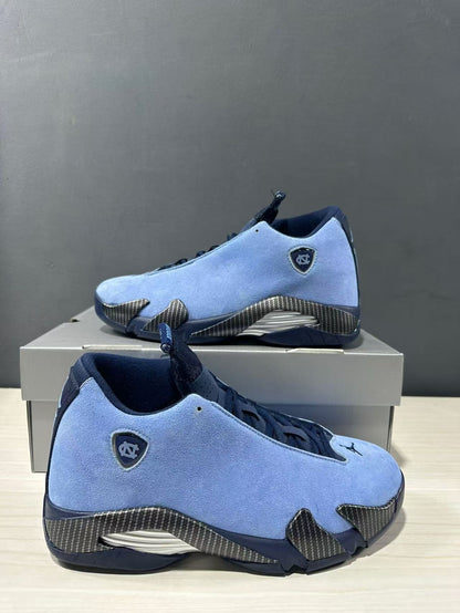 Pair of blue Jordan Air Jordan 14 sneakers shown from angled side views with navy collars and textured overlays.