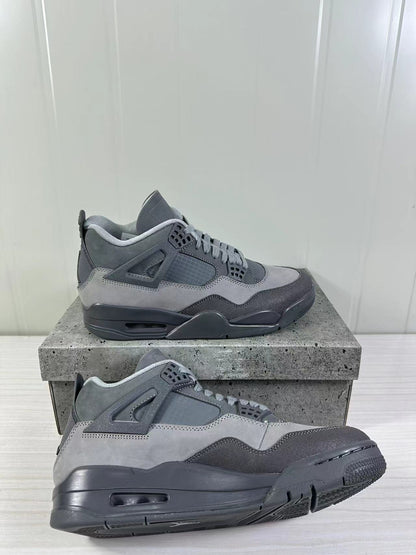 Angled side view of the pair highlighting the layered grey panels, mesh sections, and dark rubber soles.