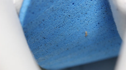 Close-up of the navy outsole surface and its textured finish.