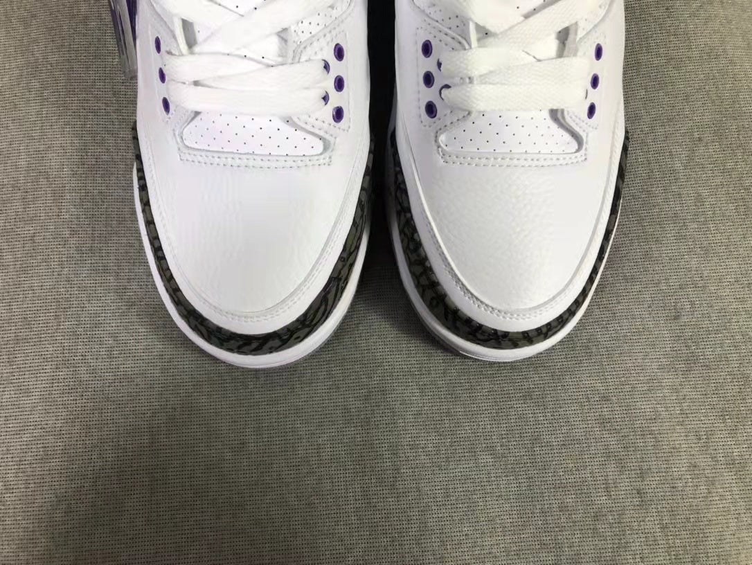 Top-down view showing the white toe boxes, laces, perforations, and dark patterned toe overlays.