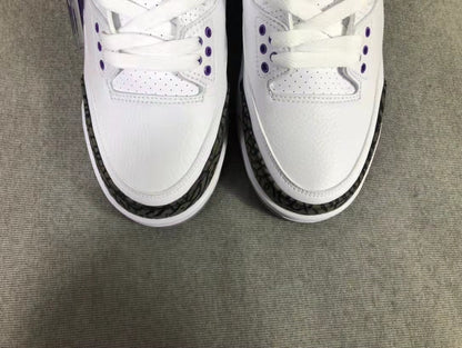 Top-down view showing the white toe boxes, laces, perforations, and dark patterned toe overlays.