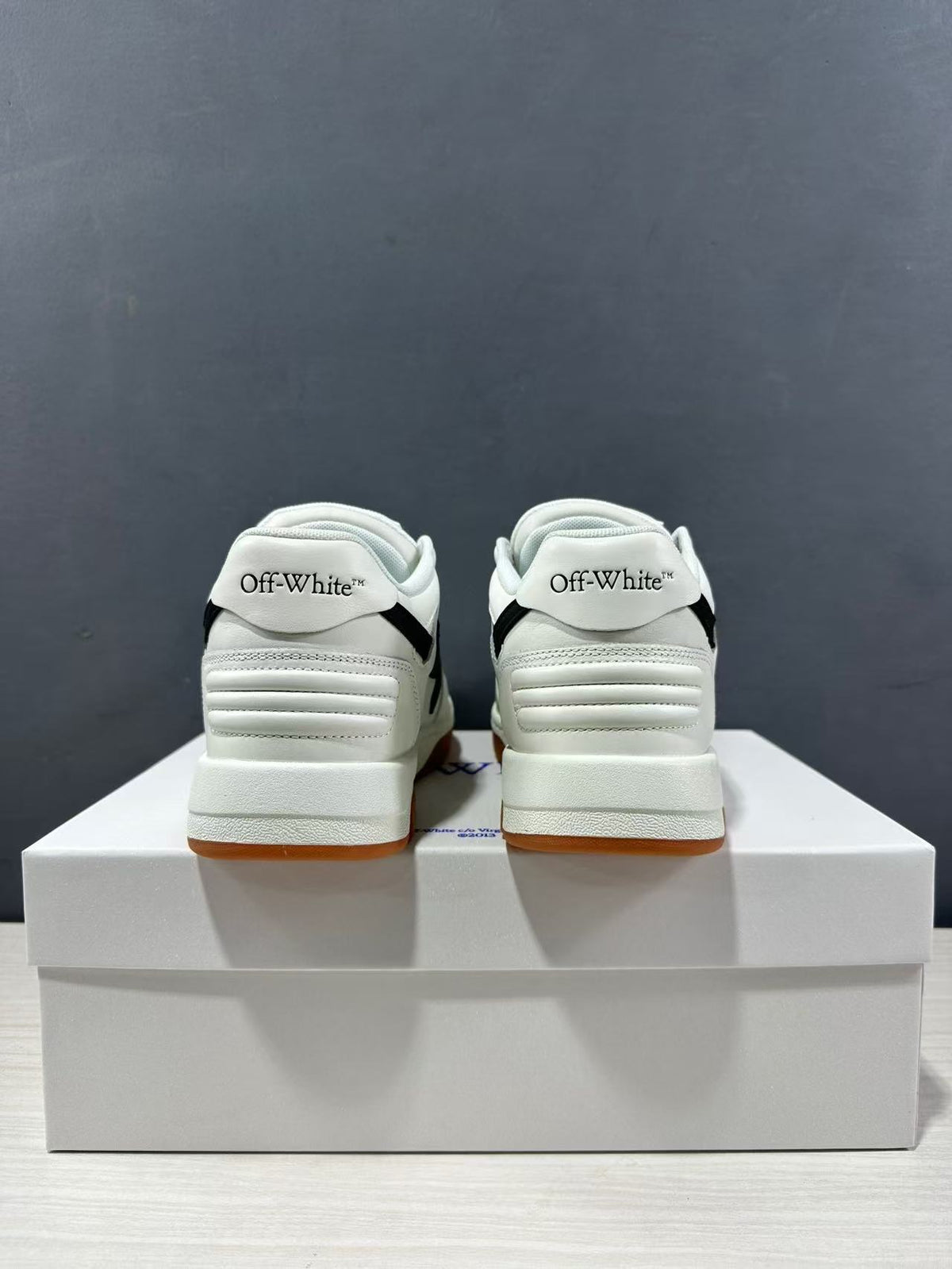Rear view showing Off-White branding on the heel tabs and padded heel construction.