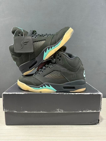Pair of dark green and black Jordan Air Jordan 5 sneakers arranged on a shoe box, showing both outer sides.