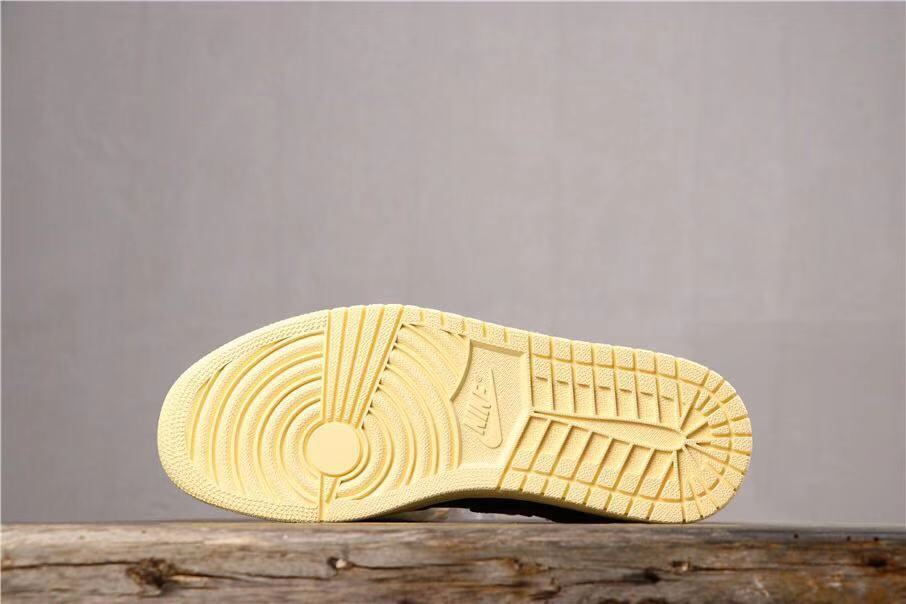 Underside view showing the cream-colored rubber outsole with circular and geometric tread sections.