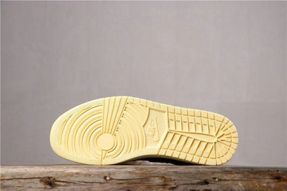 Underside view showing the cream-colored rubber outsole with circular and geometric tread sections.