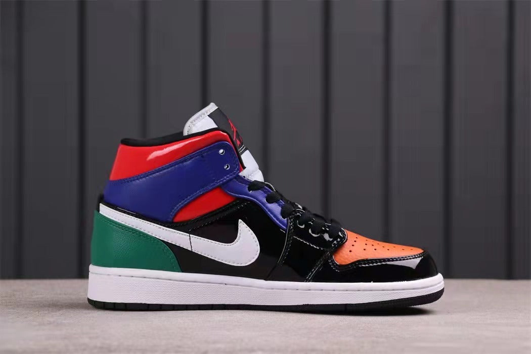 Side profile showing the mid-top shape, orange toe, black quarter panel, white swoosh, blue collar, and green heel.