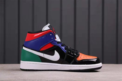 Side profile showing the mid-top shape, orange toe, black quarter panel, white swoosh, blue collar, and green heel.