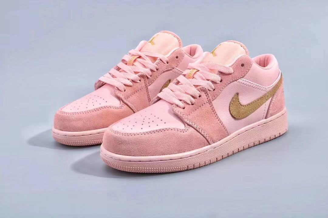 Three-quarter view of the pink sneakers with tonal laces and layered panels.