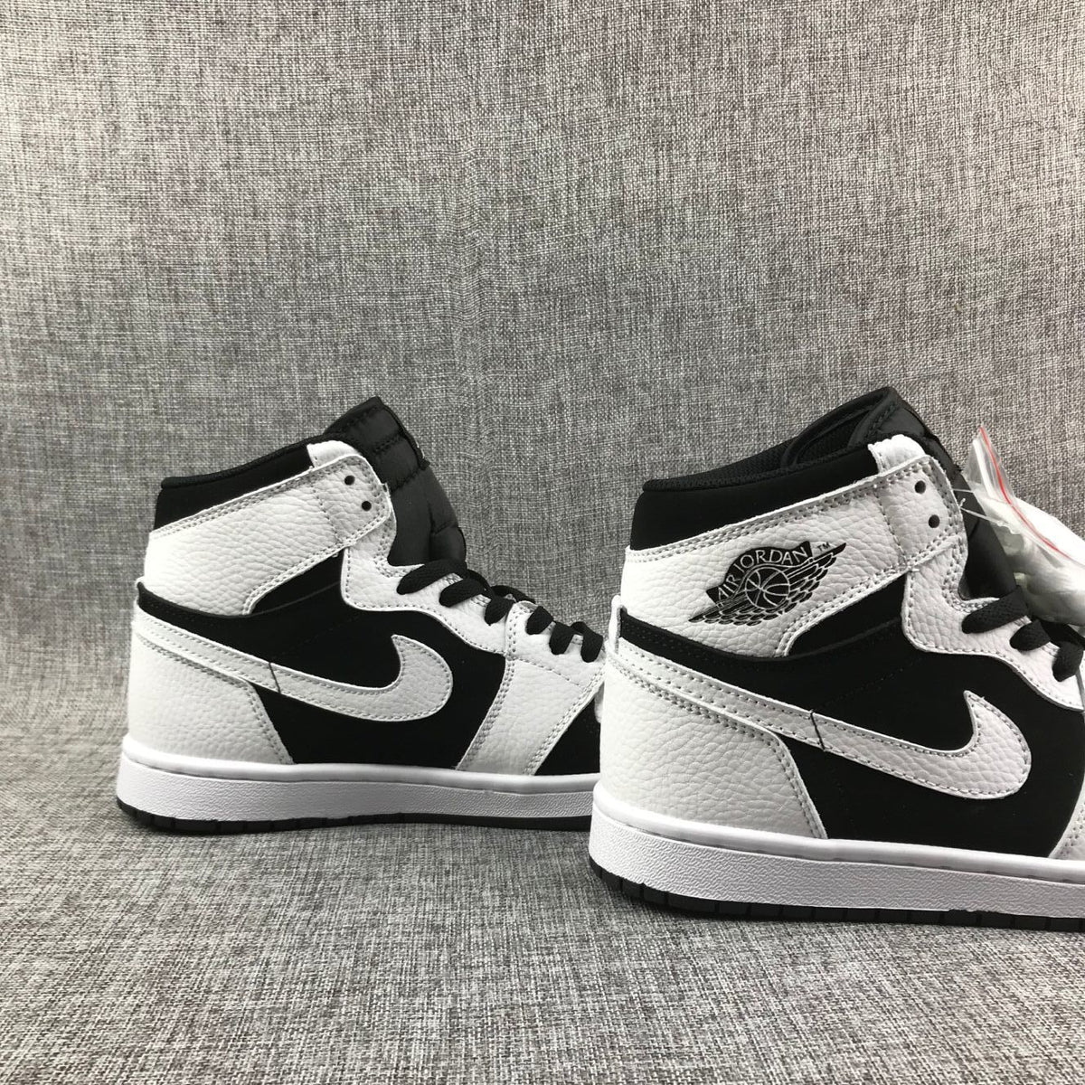 Pair of black-and-white high-top sneakers shown from the side