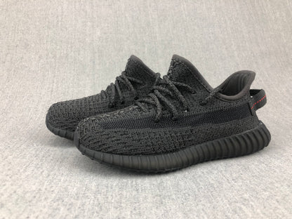 Pair of black sneakers shown from a three-quarter angle with matching ribbed soles.
