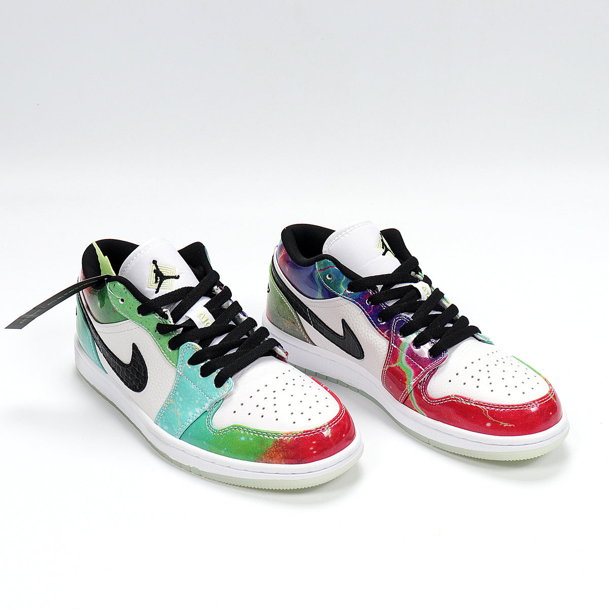 Three-quarter view of the multicolor low-top sneakers with white uppers, black accents, and light outsoles.