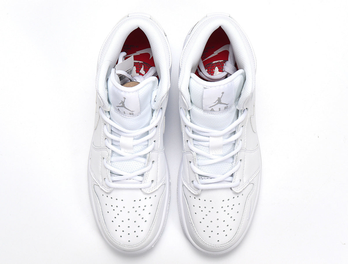 Top view of a pair of white high-top sneakers with perforated toe boxes and red interior branding.