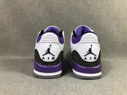 Rear view of the white and purple Jordan sneakers showing the embroidered heel logos and dark patterned heel overlays.