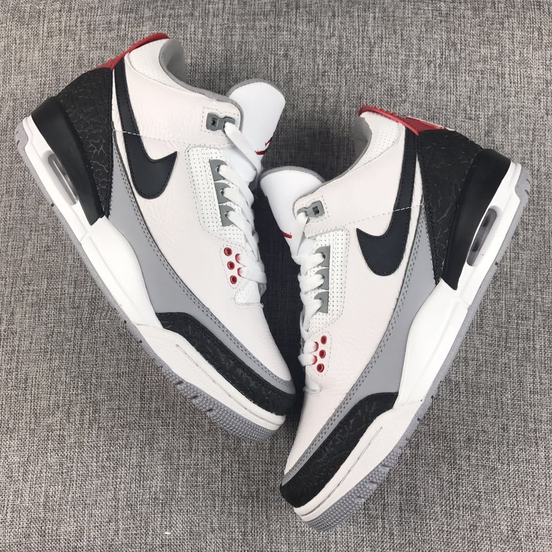 Top view of the white, black, grey, and red Jordan sneaker pair.