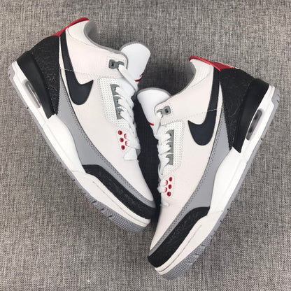 Top view of the white, black, grey, and red Jordan sneaker pair.