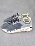Pair of grey lifestyle sneakers shown from an angled front-side view.