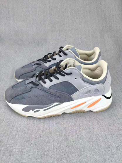 Pair of grey lifestyle sneakers shown from an angled front-side view.