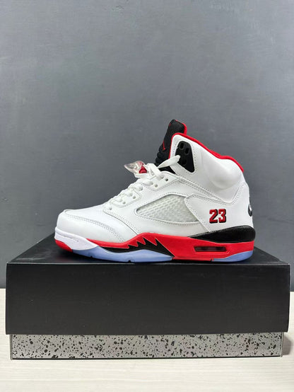 Side profile of a white high-top sneaker with red collar lining, black heel accent, mesh side panel, and visible number 23.