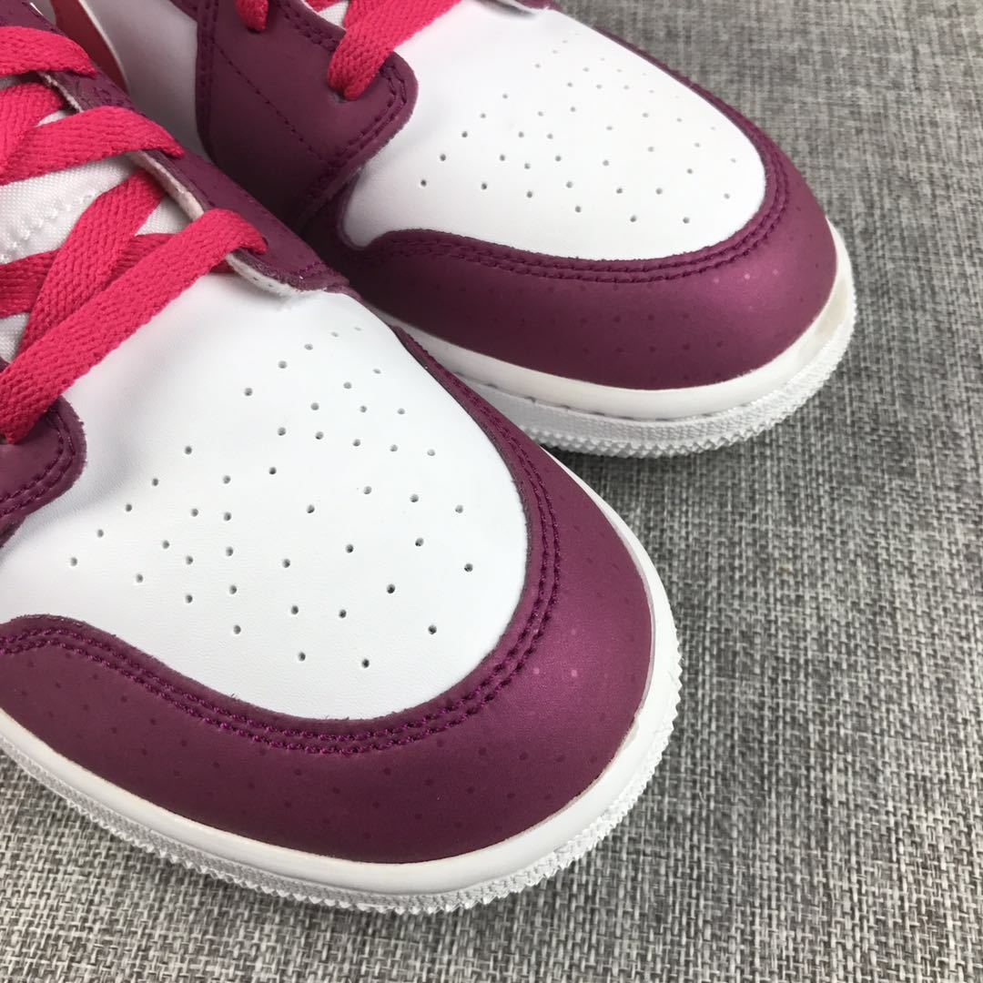 Detailed close-up of the white toe box and burgundy trim.