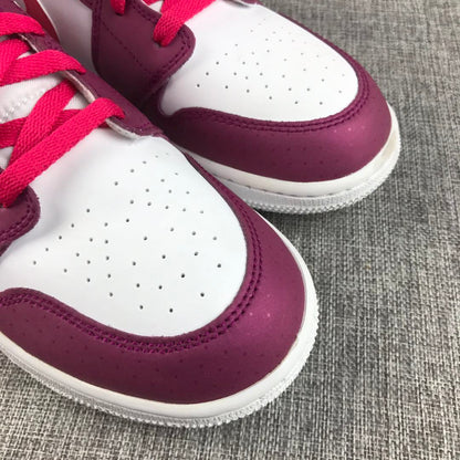 Detailed close-up of the white toe box and burgundy trim.