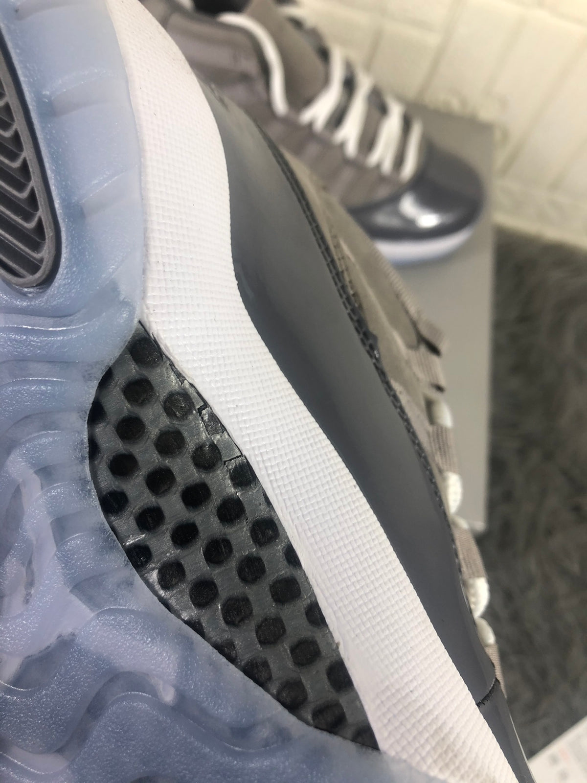 Close-up of the translucent outsole edge, white midsole, and black traction section.