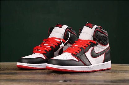 Front three-quarter view of the pair showing padded collars, red laces, white midsoles, and red outsoles.