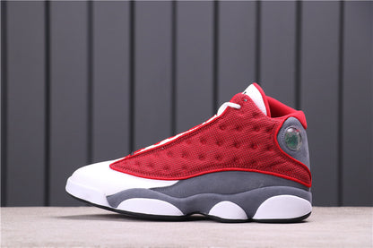 Side view of Air Jordan 13 Red Flint sneakers in red, gray, and white.