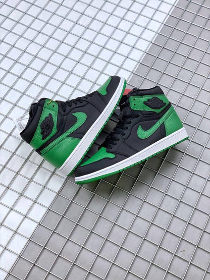 Pair of black and green high-top sneakers displayed together.