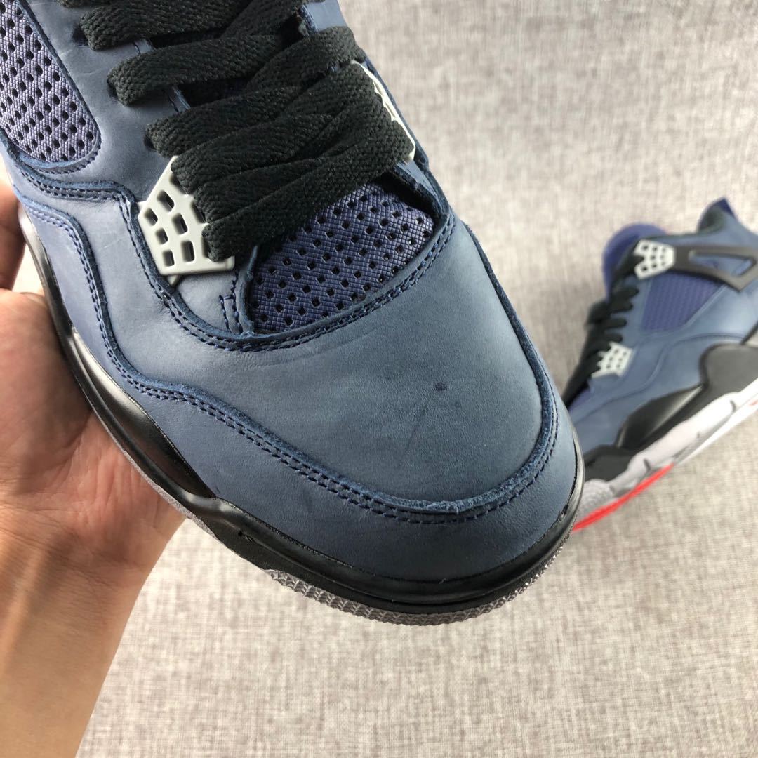 Close-up of the navy toe box, black laces, and perforated mesh panel.