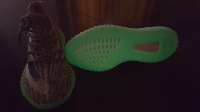 Low-light view of the sneaker upper and translucent outsole.