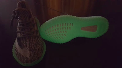 Low-light view of the sneaker upper and translucent outsole.