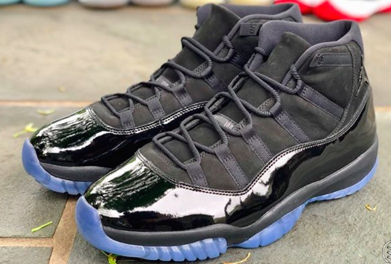 Pair of black high-top sneakers shown from the front three-quarter view.