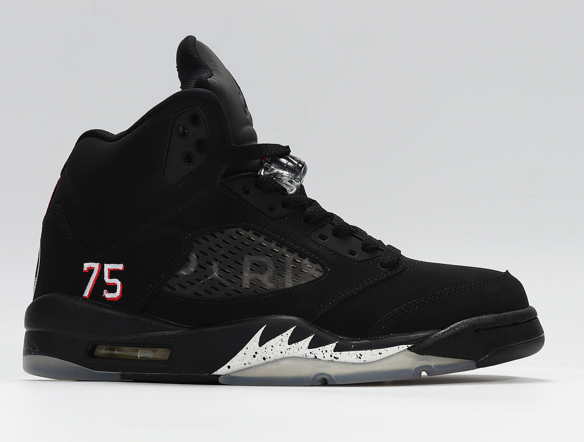 Opposite side view of the black sneaker, showing red-white accents, a number 75 detail, and translucent outsole