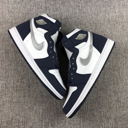 Pair of white, navy and silver high-top sneakers arranged on a fabric surface.