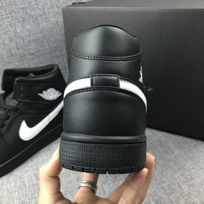 Rear view of the black sneaker showing the padded collar, heel panel and rubber outsole.
