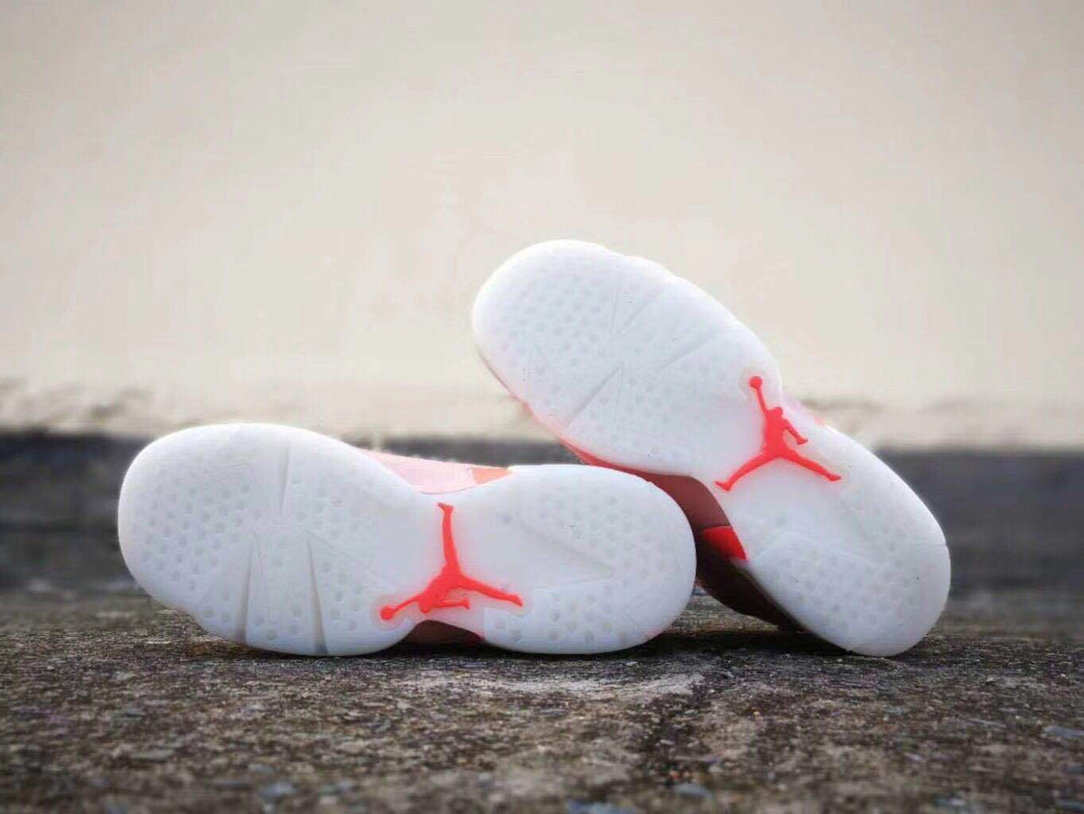 Underside view of the pair showing the white outsole tread and red Jordan branding.