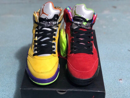 Front view of the yellow and red high-top sneakers with contrasting tongues, laces, and color-blocked soles.