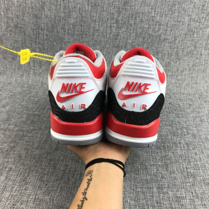 Rear view showing red Jordan branding, white heel panels, and black textured overlays.