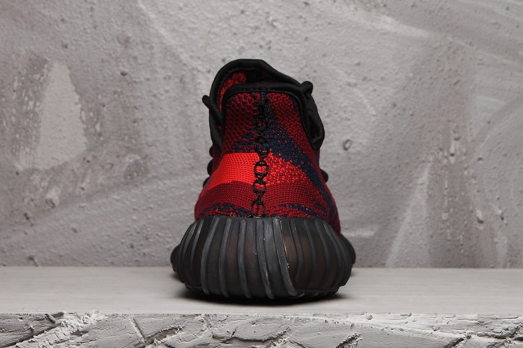Rear view showing the black-and-red knit heel and ribbed dark outsole.