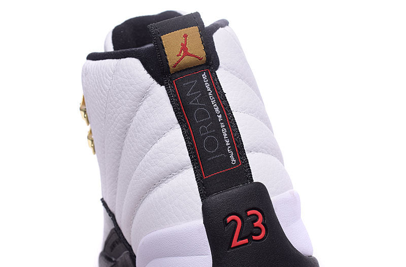 Close-up of the white and black high-top sneaker heel showing the Jordan tongue label, red-outlined black pull tab, and red 23 graphic.